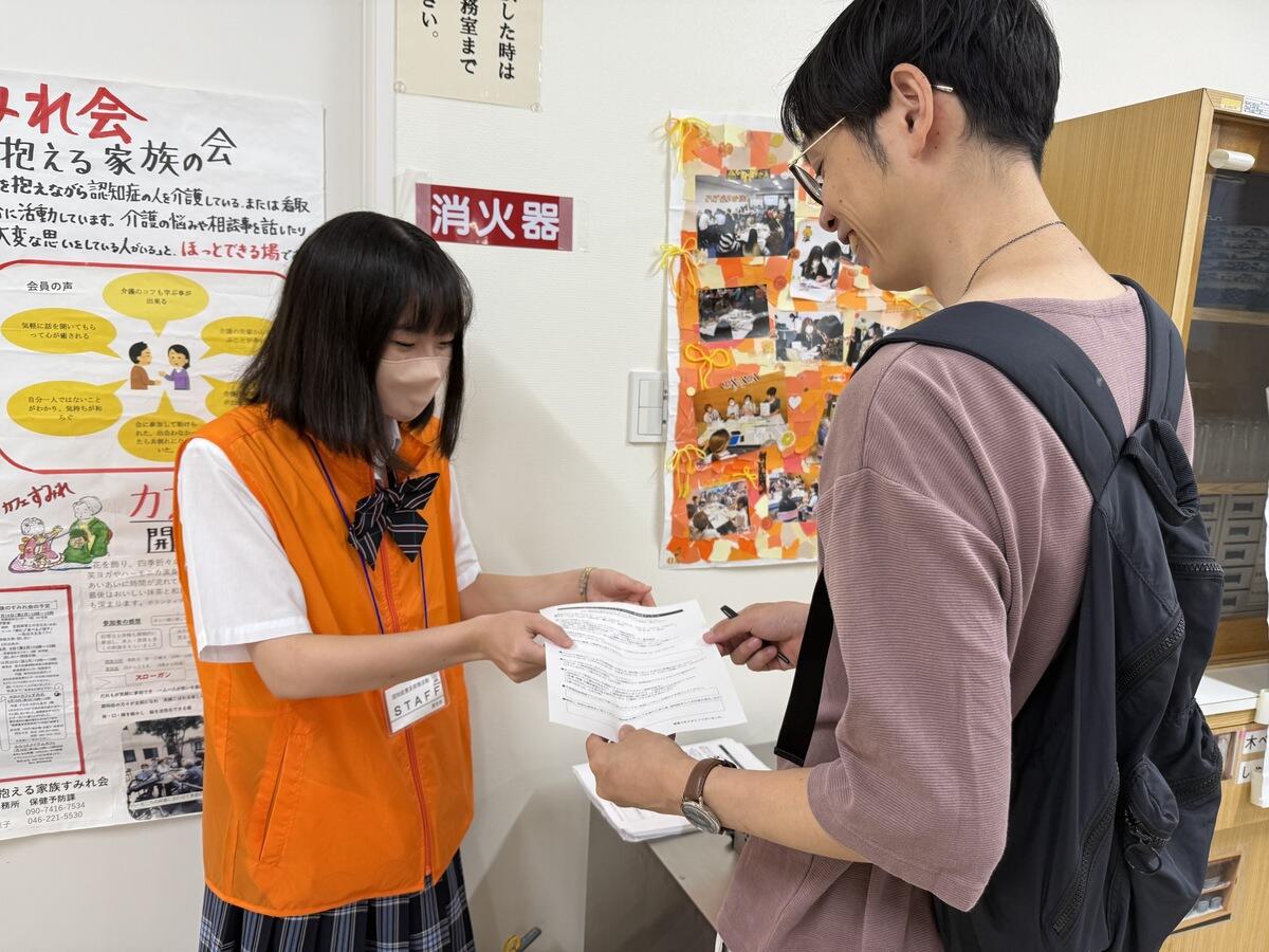 アンケートの声掛けをする生徒