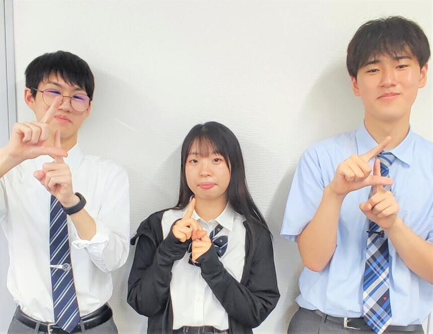 3人の生徒が手話で「千葉」を表している様子