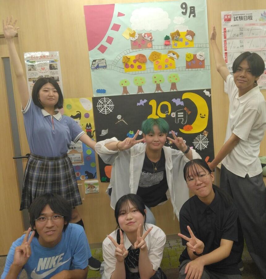 女子生徒4人と男子生徒2人が自分で作成した制作物の前でポーズをしている写真
