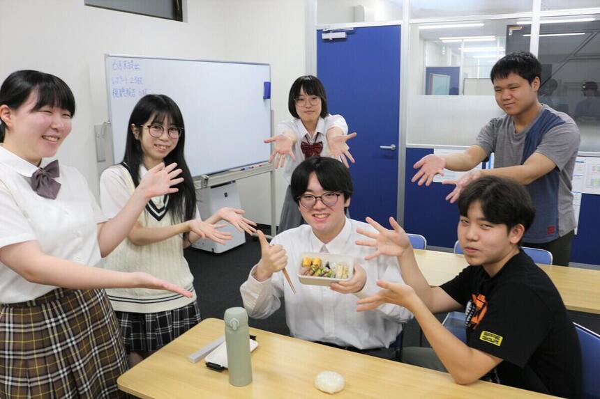 昼休みの時間に友だちと楽しそうに自分で作ったお弁当を食べている様子