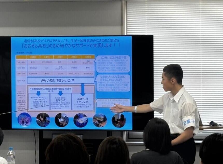 男子生徒が学校説明でスライドを指しながら説明している画像