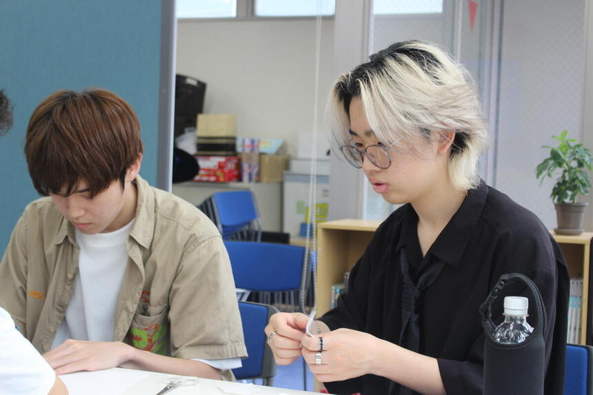 貿易ゲームで紙を切る生徒の様子