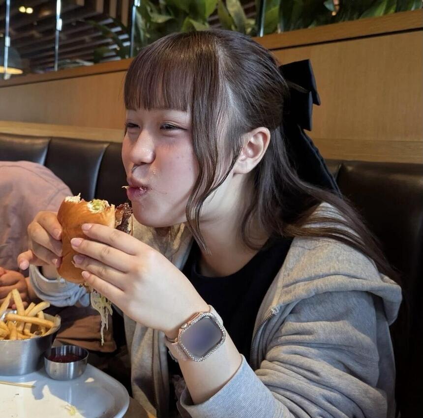 バンクーバー滞在中に、2年次生のMさんが大きなハンバーガーを笑顔で食べている様子
