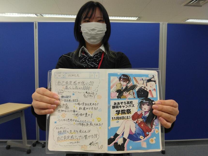 みらいノートを見せてくれる生徒。左が自分を認めてあげるページ、右はおおぞら高校静岡キャンパス学院祭で作成したポスター