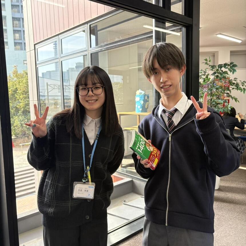 ピースをしている教員と単語帳を持ちピースをしている生徒